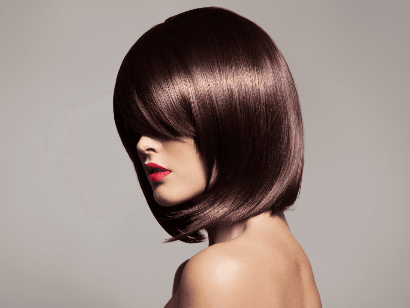 Woman with rich, glossy brunette hair after a demi colour gloss at Baileys Hairdressing Grantham, showcasing vibrant tone and silky shine.