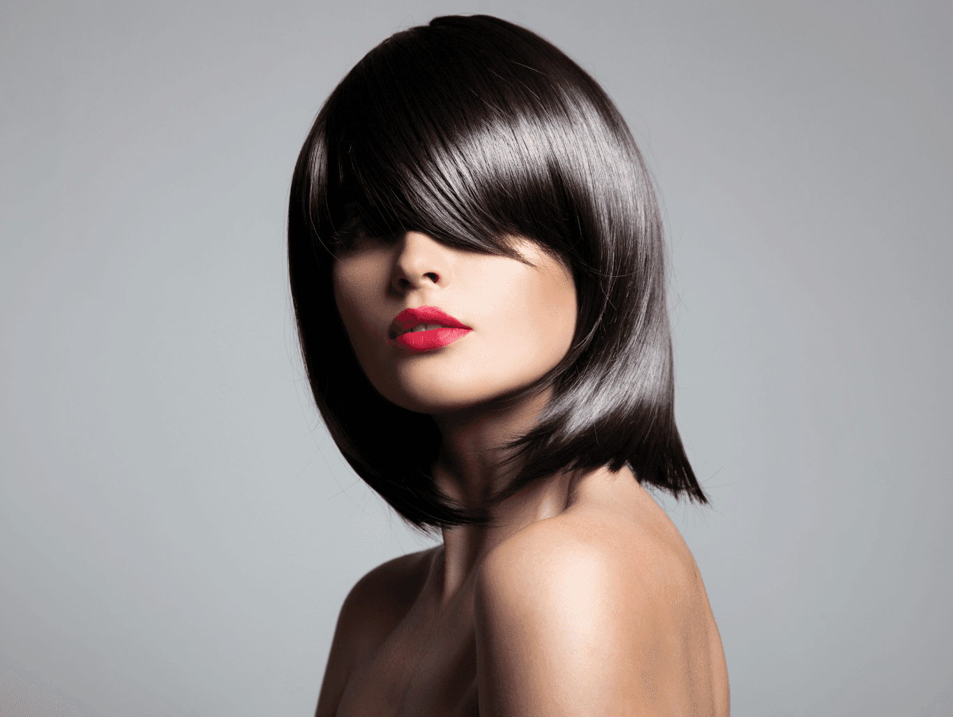 Woman with sleek, glossy, dark full head tinted hair at Baileys Hairdressing Grantham, showcasing even, vibrant, all-over colour.
