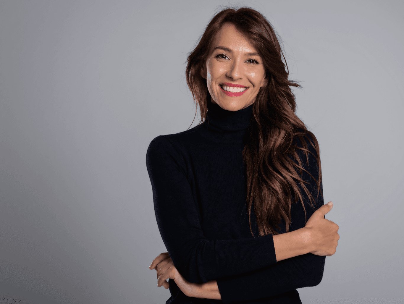 Smiling brunette woman with long, sleek, glossy hair after a professional blow-dry at Baileys Hairdressing Grantham, styled for shine and movement.