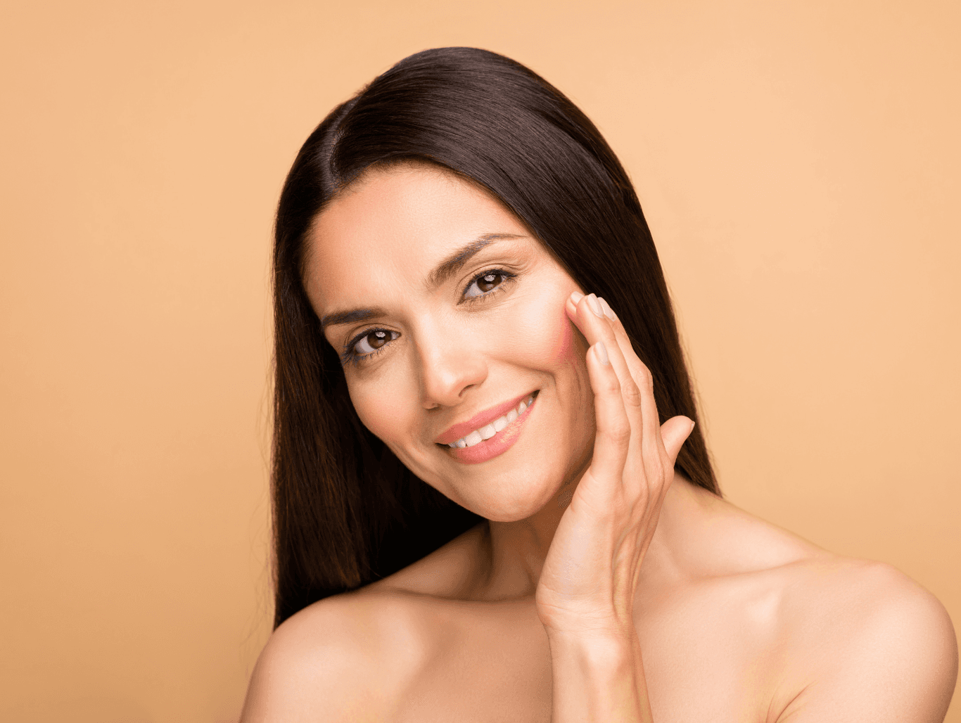 Smiling woman with sleek, freshly tinted dark brown hair at Baileys Hairdressing Grantham, showcasing smooth, even, and glossy regrowth coverage.